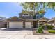 Charming two-story home with a three-car garage and desert landscaping at 13545 W Caribbean Ln, Surprise, AZ 85379