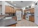 Well-lit kitchen with white appliances, ample counter space, and tile flooring at 13545 W Caribbean Ln, Surprise, AZ 85379