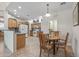 Eat-in kitchen featuring wood cabinets, tile floors, and an island counter at 13545 W Caribbean Ln, Surprise, AZ 85379