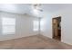 Carpeted bedroom featuring natural light from two windows and a view into the en-suite bathroom at 1361 W Roosevelt Ave, Coolidge, AZ 85128