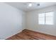 Bright bedroom featuring hardwood floors, ceiling fan, and a window with blinds at 1361 W Roosevelt Ave, Coolidge, AZ 85128