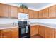 Kitchen showcases ample wood cabinetry, modern appliances, and a stylishly arranged countertop with decor at 1361 W Roosevelt Ave, Coolidge, AZ 85128