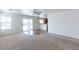 Bright living room with neutral carpet and a view into the kitchen at 1361 W Roosevelt Ave, Coolidge, AZ 85128