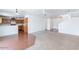 Open-concept living area with a mix of carpet and wood flooring, seamlessly connected to the kitchen and stairway at 1361 W Roosevelt Ave, Coolidge, AZ 85128