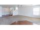 Spacious living room with neutral carpet, stairs, and a view into the entry foyer at 1361 W Roosevelt Ave, Coolidge, AZ 85128