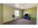 This bedroom features a neutral color scheme, with light green walls, a ceiling fan, and plush carpeting at 13834 N 39Th Ln, Phoenix, AZ 85053