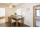 Cozy dining area featuring a wooden table set, natural light, and wood-look tile flooring at 13834 N 39Th Ln, Phoenix, AZ 85053