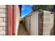 Side yard with a walkway and metal storage shed, all contained by block wall at 13834 N 39Th Ln, Phoenix, AZ 85053