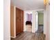 Hallway with wood-look floors, a built in cabinet, and access to rooms with neutral wall colors at 13834 N 39Th Ln, Phoenix, AZ 85053