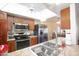 Bright kitchen with stainless steel appliances, wood cabinets, granite countertops, and a view into the dining area at 13834 N 39Th Ln, Phoenix, AZ 85053