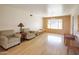 Bright living room featuring hardwood floors, neutral walls, large window, and comfortable seating at 13834 N 39Th Ln, Phoenix, AZ 85053