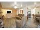 Open concept living room showcasing a fireplace, tile floors, and seamless flow into the dining area and kitchen at 13834 N 39Th Ln, Phoenix, AZ 85053