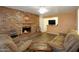 Spacious living room featuring a fireplace, a ceiling fan, and comfortable seating, creating a relaxed ambiance at 13834 N 39Th Ln, Phoenix, AZ 85053