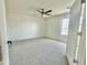 Bright bedroom featuring neutral carpeting, a ceiling fan, and natural light at 1492 S 218Th Ln, Buckeye, AZ 85326