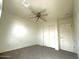 Clean bedroom with neutral carpet, ceiling fan, and double door closet, offering a blank canvas for personalization at 1492 S 218Th Ln, Buckeye, AZ 85326