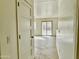 Bright hallway featuring tile floors that lead out to a sliding glass door at 1492 S 218Th Ln, Buckeye, AZ 85326