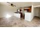 Open concept living and kitchen area featuring breakfast bar and tile floors at 1492 S 218Th Ln, Buckeye, AZ 85326