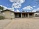 View of the back of the home with covered patio and dirt backyard at 1512 N Iowa St, Chandler, AZ 85225