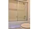 Full bathroom featuring shower-tub combo with glass doors at 1512 N Iowa St, Chandler, AZ 85225