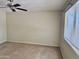 This empty bedroom is painted a neutral color and has a ceiling fan at 1512 N Iowa St, Chandler, AZ 85225