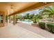 Inviting backyard featuring a covered patio, lush landscaping, and a sparkling pool at 17218 W Mahogany Way, Surprise, AZ 85387