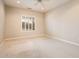 The bright, carpeted bedroom features plantation shutters and neutral colored walls at 17218 W Mahogany Way, Surprise, AZ 85387