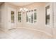 Bright dining area with tile floors, plantation shutters, and chandelier at 17218 W Mahogany Way, Surprise, AZ 85387