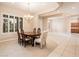 Elegant dining area featuring a stylish chandelier, plantation shutters, and ample natural light at 17218 W Mahogany Way, Surprise, AZ 85387