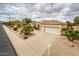 Aerial front exterior view with neutral colored home, tile roof, and desert landscaping at 17218 W Mahogany Way, Surprise, AZ 85387