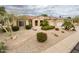 Charming single-story home with a well-manicured desert-landscaped front yard and a three-car garage at 17218 W Mahogany Way, Surprise, AZ 85387