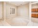 Inviting living area with plantation shutters, plush carpeting, and built-in cabinets at 17218 W Mahogany Way, Surprise, AZ 85387