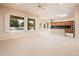 Open-concept living room with bright windows and a view to the pool and outdoor living area at 17218 W Mahogany Way, Surprise, AZ 85387