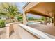 Covered patio featuring a view of the swimming pool with lush landscaping at 17218 W Mahogany Way, Surprise, AZ 85387