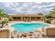 Backyard oasis featuring a pool with lush landscaping for a serene and private retreat at 17218 W Mahogany Way, Surprise, AZ 85387