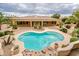 Inviting kidney-shaped pool with rock feature complements the home's outdoor living space at 17218 W Mahogany Way, Surprise, AZ 85387