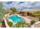 Aerial view of the backyard showcasing a private pool, covered patio, and manicured landscaping at 17218 W Mahogany Way, Surprise, AZ 85387