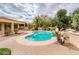 Private pool area surrounded by mature trees and landscaping provides a serene escape at 17218 W Mahogany Way, Surprise, AZ 85387