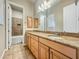 Bathroom with tile flooring, granite countertop, and double sinks at 17346 W Lincoln St, Goodyear, AZ 85338