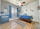 Comfortable bedroom with ceiling fan, wood-look flooring, and blue accents at 17346 W Lincoln St, Goodyear, AZ 85338