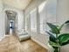 Hallway featuring decorative steps, windows, and tile flooring at 17346 W Lincoln St, Goodyear, AZ 85338