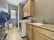 Laundry room featuring sink, granite countertop, and a washing machine at 17346 W Lincoln St, Goodyear, AZ 85338