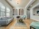 Bright living room featuring recessed shelving, comfortable seating, neutral tones, and large windows at 17346 W Lincoln St, Goodyear, AZ 85338