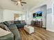 Inviting living room with large sectional sofa, wood floors and recessed lighting at 17346 W Lincoln St, Goodyear, AZ 85338