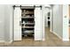 Well-organized pantry with sliding barn doors, providing plenty of storage in the kitchen area at 17346 W Lincoln St, Goodyear, AZ 85338