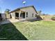 Spacious backyard features grass, a covered patio, and block fencing at 18151 N 88Th Dr, Peoria, AZ 85382