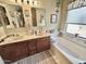 Bathroom features a vanity with double sinks and a soaking tub at 18151 N 88Th Dr, Peoria, AZ 85382