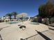 Community pool and spa area with palm trees and a shade umbrella at 18151 N 88Th Dr, Peoria, AZ 85382