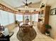 Bright dining area features a ceiling fan and a bay window with a view of the outdoors at 18151 N 88Th Dr, Peoria, AZ 85382