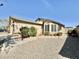 Charming single-story home featuring a desert landscape, a bay window, and an inviting walkway to the front door at 18151 N 88Th Dr, Peoria, AZ 85382