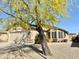 Single-story home with a well-manicured desert landscape, a covered entry, and a two-car garage at 18151 N 88Th Dr, Peoria, AZ 85382